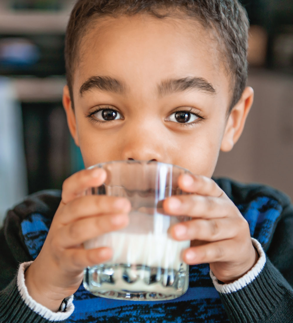 Young boy drinking milk