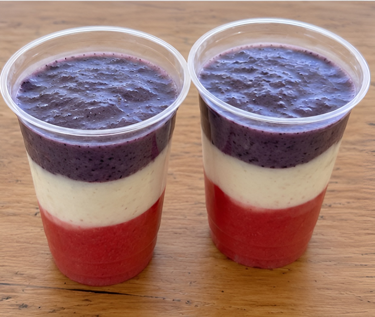 Two cups of red, white, and blue smoothies