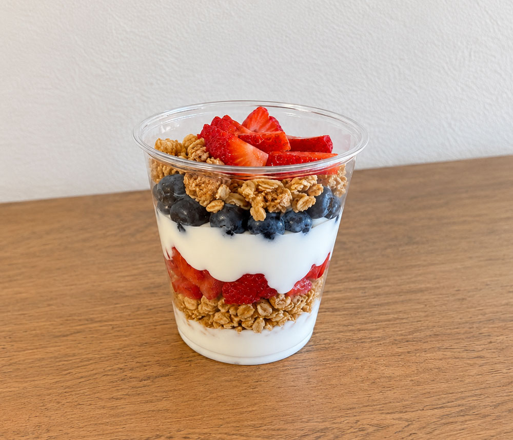 Yogurt parfait layered with granola, strawberries, blueberries